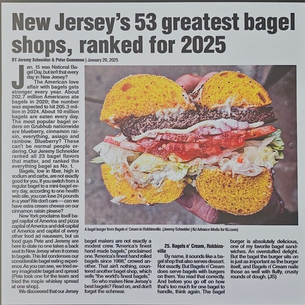A large bagel burger from Bagels N' Cream, with a thick patty, lettuce, and tomato.