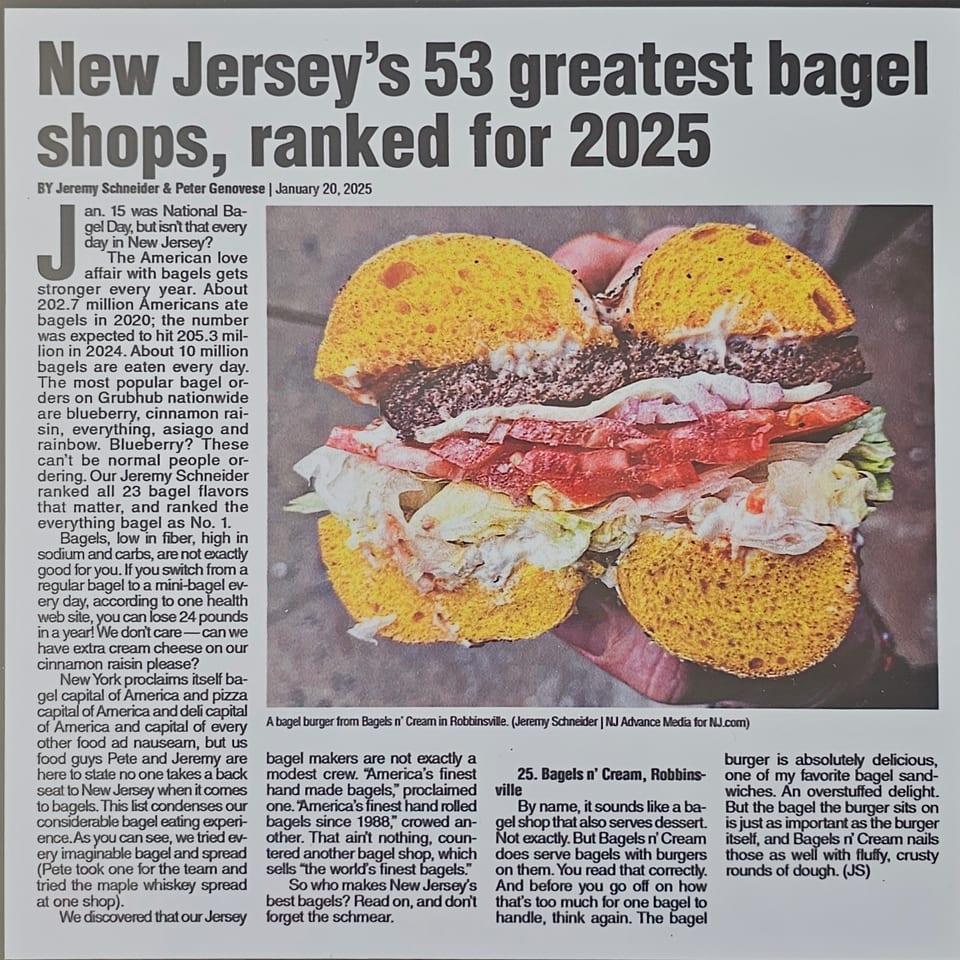 A large bagel burger from Bagels N' Cream, with a thick patty, lettuce, and tomato.