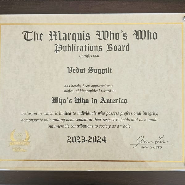 A framed certificate from The Marquis Who's Who Publications Board for Vedat Saygili.