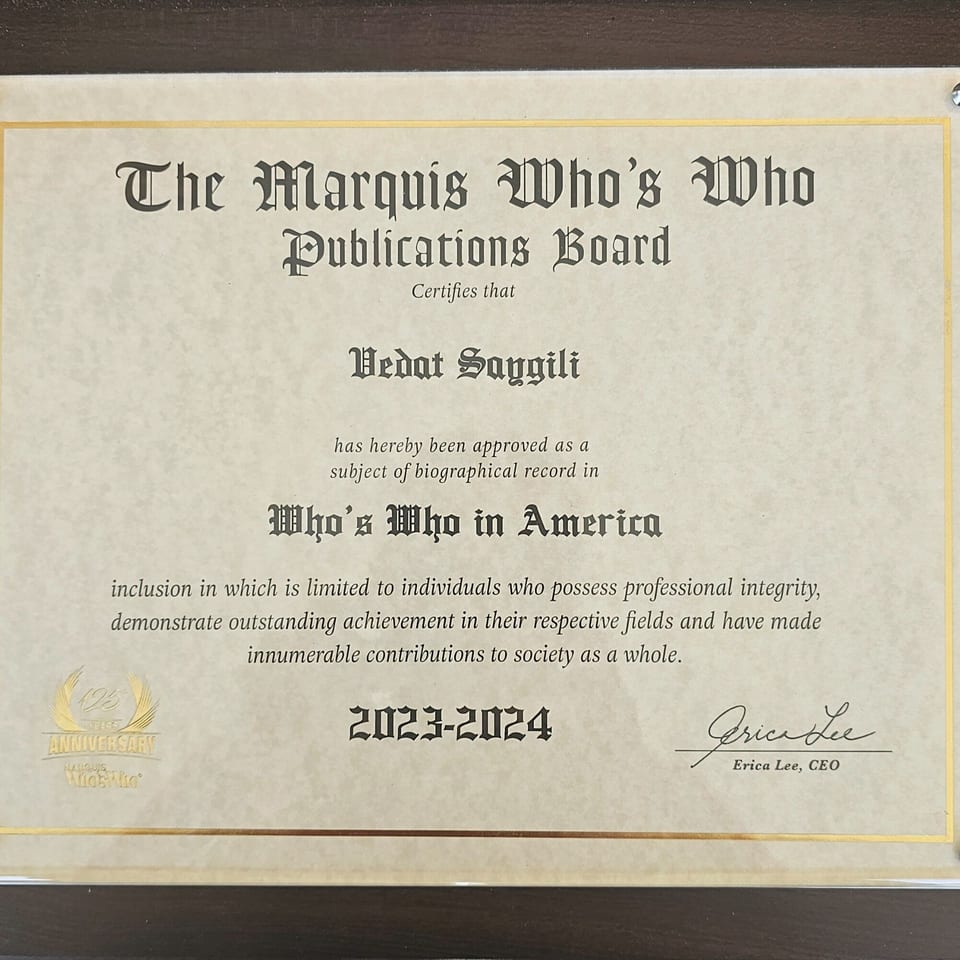 A framed certificate from The Marquis Who's Who Publications Board for Vedat Saygili.