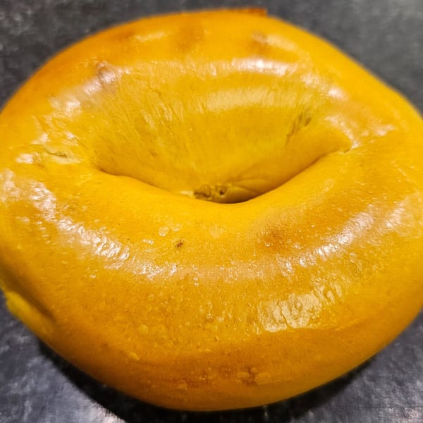 A golden-brown bagel from Bagels N' Cream, perfectly baked and ready to eat.